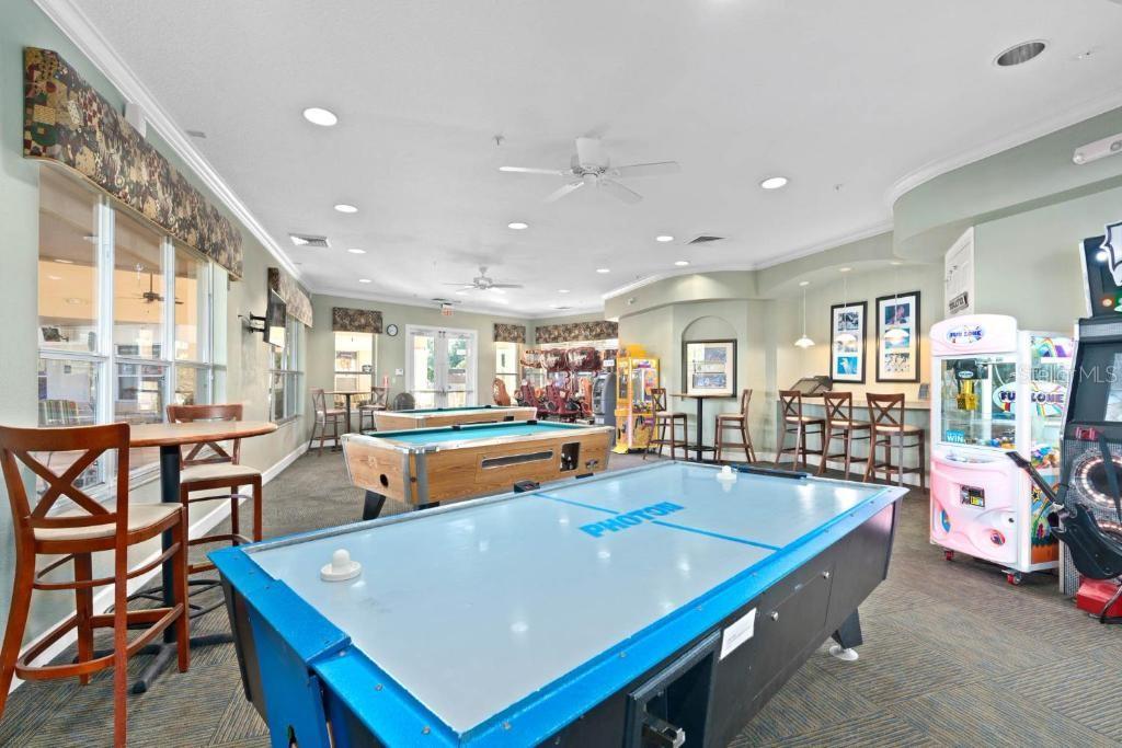 2817 Almaton Loop, Unit 304 Kissimmee, FL 34747 - Photo 21 of 26 a room with table chairs and wooden floor