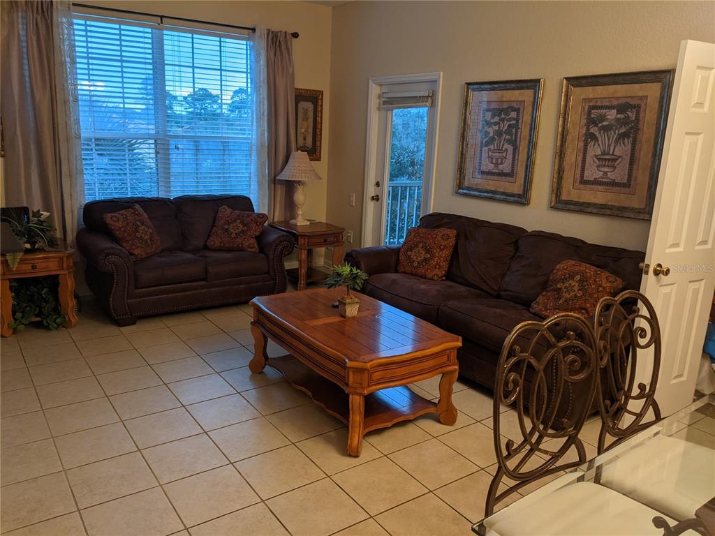 2817 Almaton Loop, Unit 304 Kissimmee, FL 34747 - Photo 7 of 26 a living room with furniture and a window