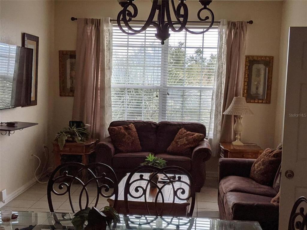 2817 Almaton Loop, Unit 304 Kissimmee, FL 34747 - Photo 9 of 26 a living room with furniture and a window