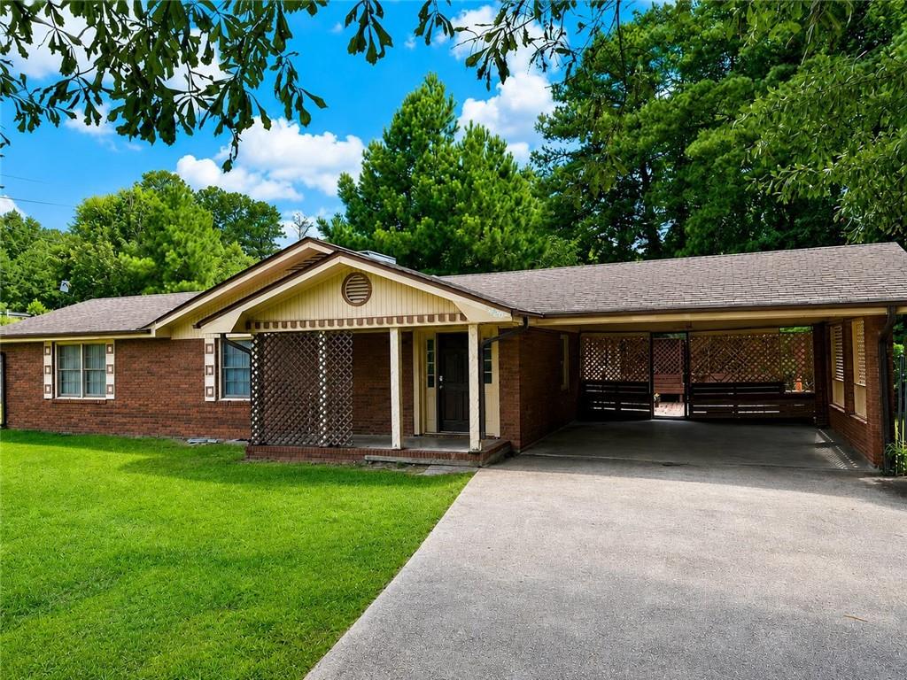 5960 Buffington Road Atlanta, GA 30349 - Photo 1 of 9 a front view of a house with a garden and trees