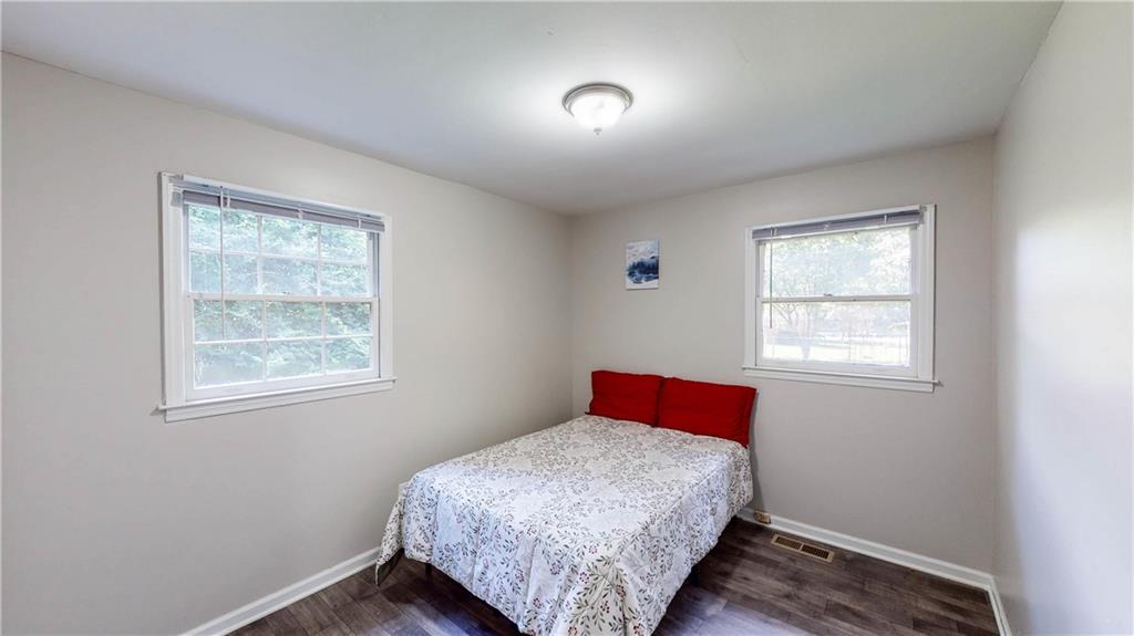 5960 Buffington Road Atlanta, GA 30349 - Photo 5 of 9 a bedroom with a bed and a window