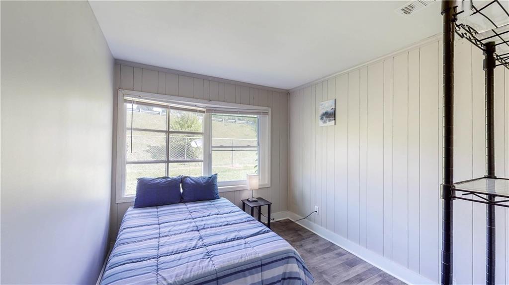 5960 Buffington Road Atlanta, GA 30349 - Photo 7 of 9 a bed sitting in a bedroom next to a window