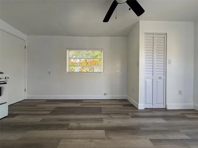 a view of room with hardwood floor and window