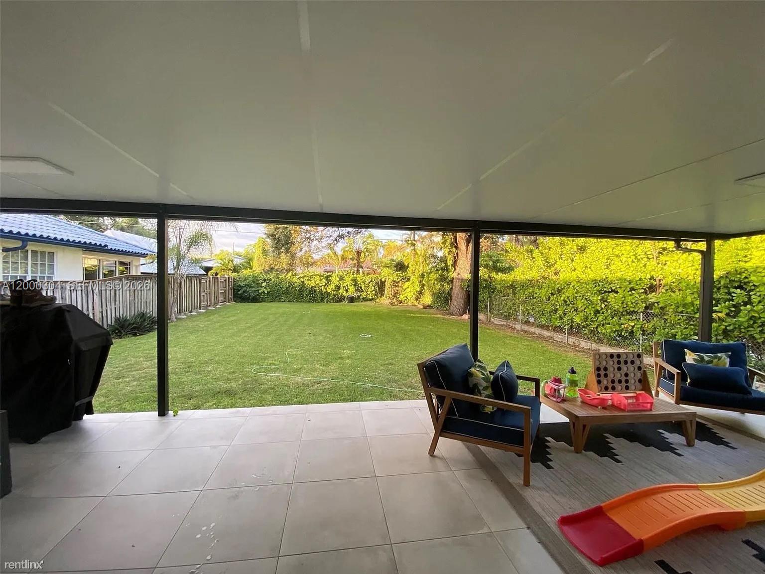 1935 Southwest 24th Terrace Miami, FL 33145 - Photo 7 of 7 a living room filled with furniture and a garden
