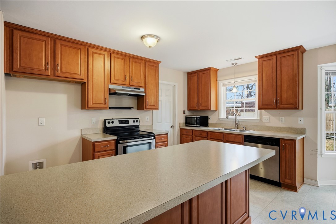 3007 Valleyfield Road Henrico, VA 23228 - Photo 11 of 38 a kitchen with stainless steel appliances a stove sink microwave and cabinets