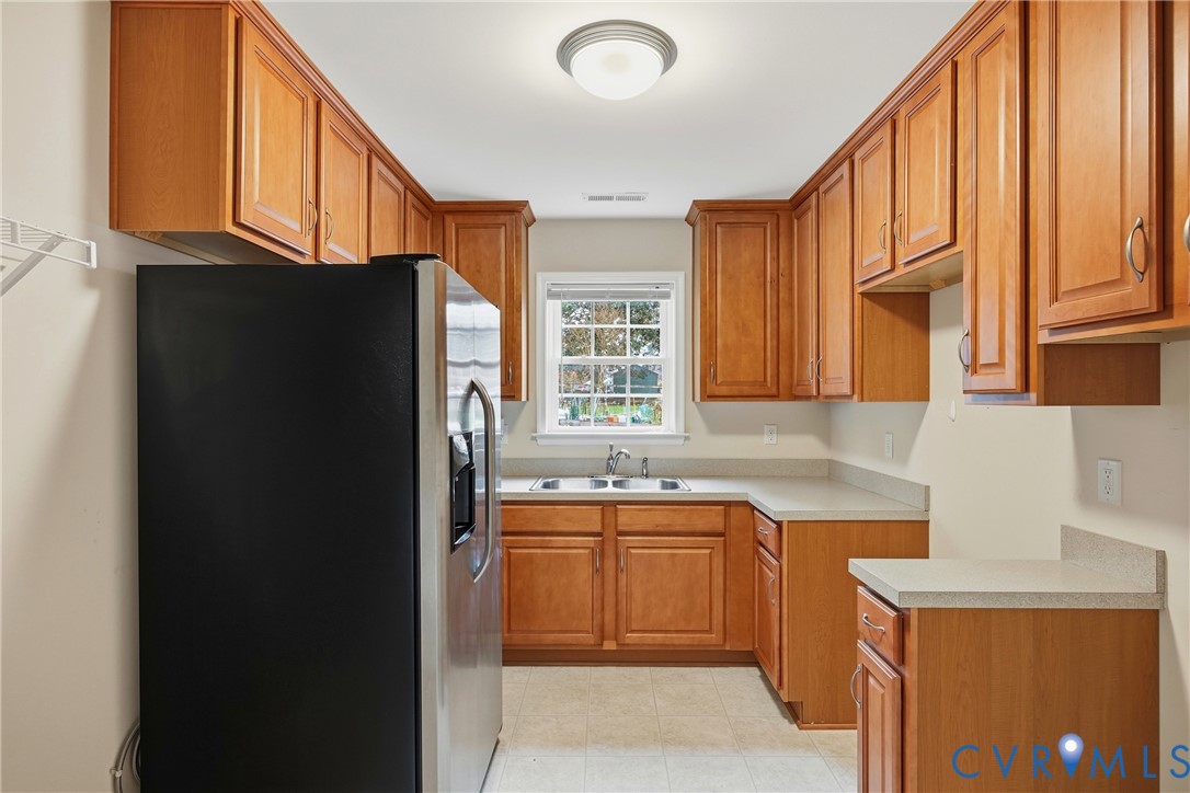 3007 Valleyfield Road Henrico, VA 23228 - Photo 15 of 38 a kitchen with a sink a refrigerator and cabinets