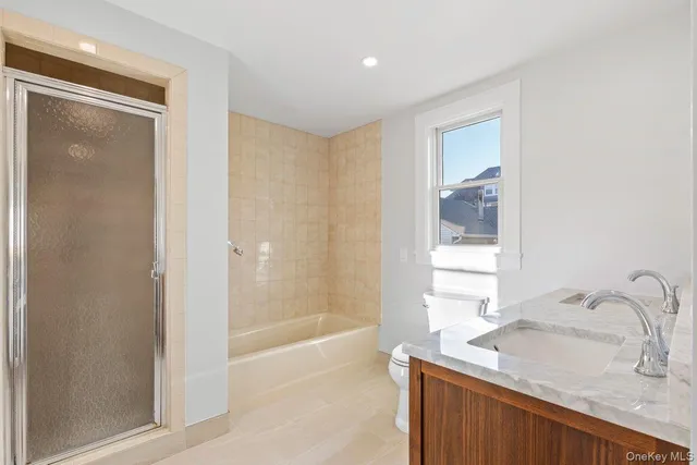 a bathroom with a granite countertop sink a mirror and a bathtub