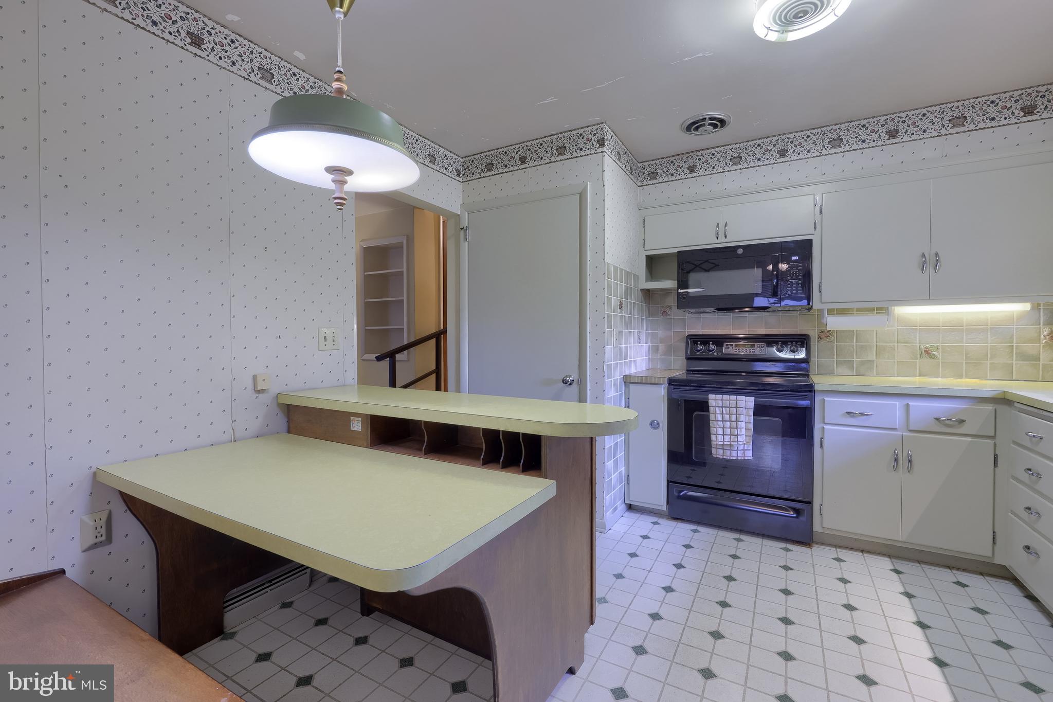 136 Springhouse Road Lancaster, PA 17603 - Photo 14 of 30 a kitchen with stainless steel appliances a stove a sink dishwasher and cabinets with wooden floor