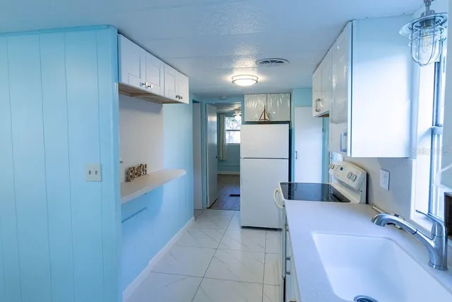 a kitchen with stainless steel appliances a refrigerator and a sink