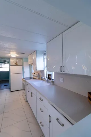 a kitchen with stainless steel appliances white cabinets and a refrigerator