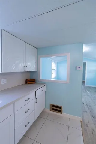 a stove top oven sitting inside of a kitchen