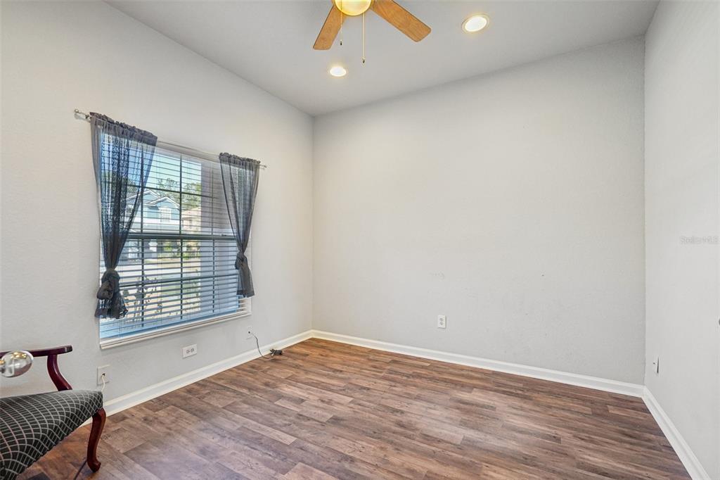 4127 Southwest 51st Court Ocala, FL 34474 - Photo 14 of 32 an empty room with wooden floor and windows