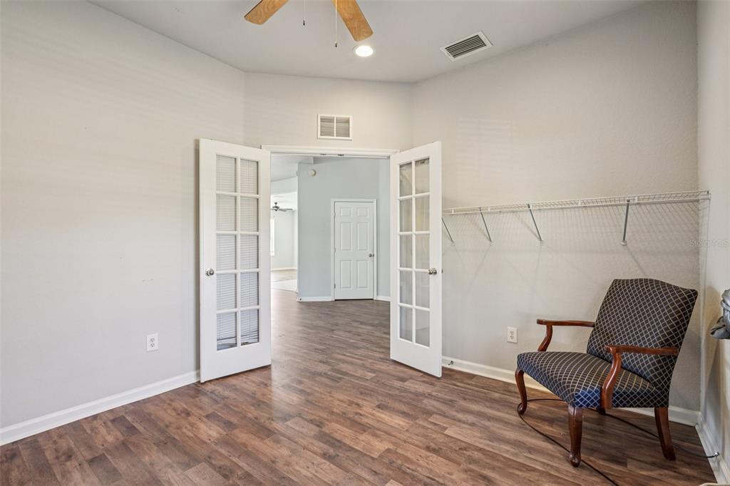 4127 Southwest 51st Court Ocala, FL 34474 - Photo 15 of 32 a view of a hallway with wooden floor and a cabinet