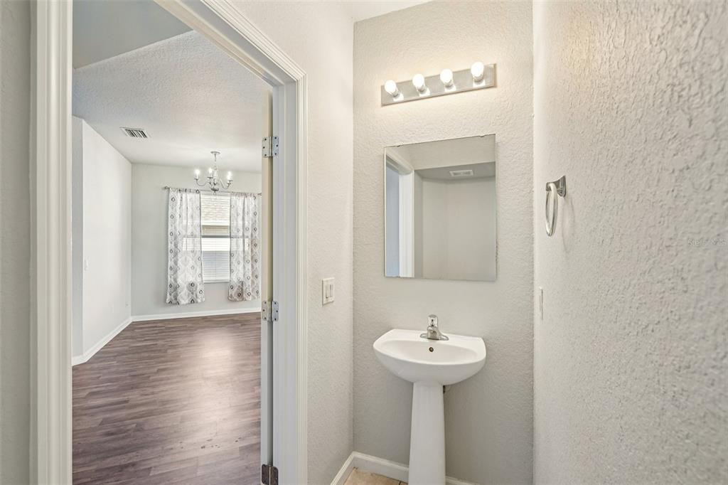 4127 Southwest 51st Court Ocala, FL 34474 - Photo 16 of 32 a bathroom with a sink a mirror and shower