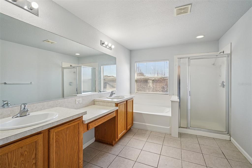 4127 Southwest 51st Court Ocala, FL 34474 - Photo 20 of 32 a bathroom with a granite countertop sink and mirror