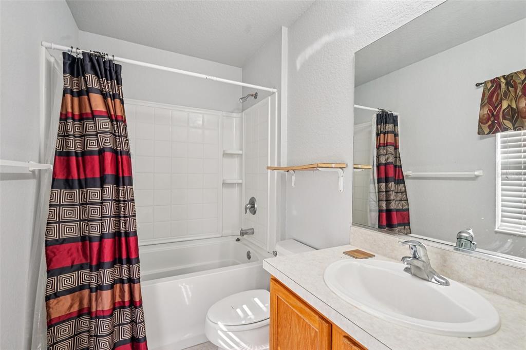 4127 Southwest 51st Court Ocala, FL 34474 - Photo 23 of 32 a bathroom with a sink toilet and shower