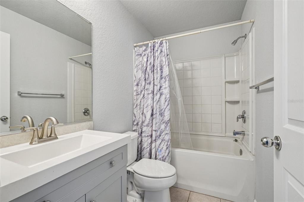 4127 Southwest 51st Court Ocala, FL 34474 - Photo 26 of 32 a bathroom with a sink a toilet and shower