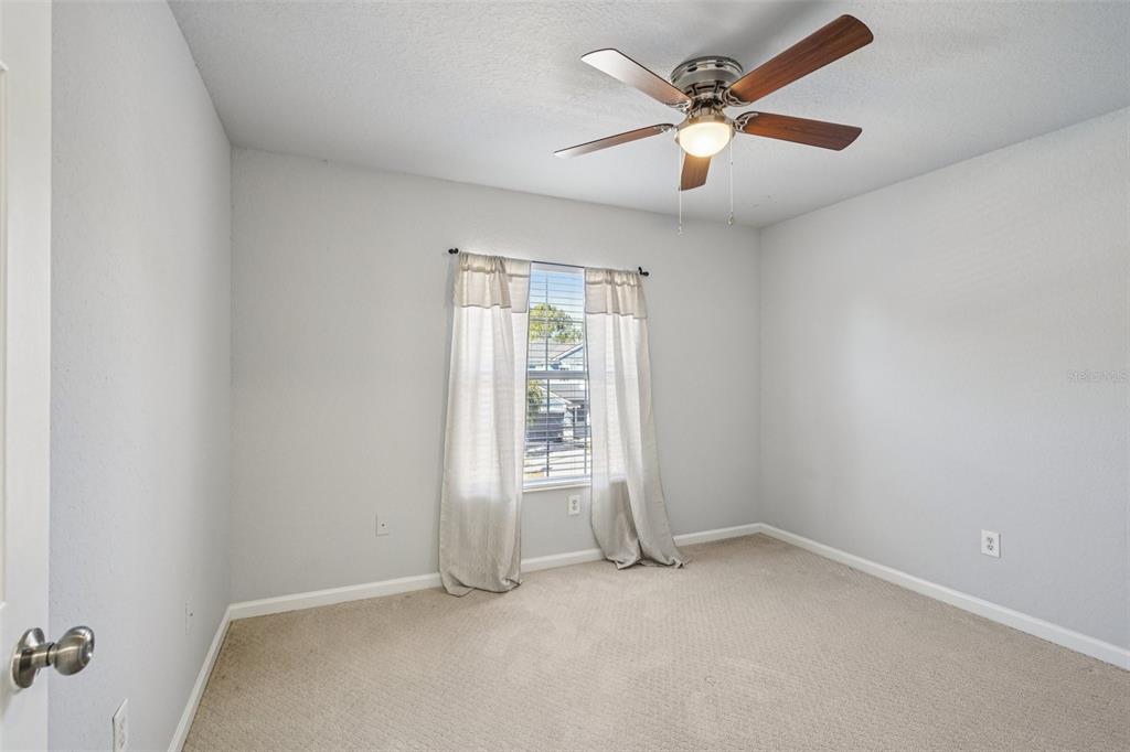 4127 Southwest 51st Court Ocala, FL 34474 - Photo 27 of 32 an empty room with closet and a ceiling fan