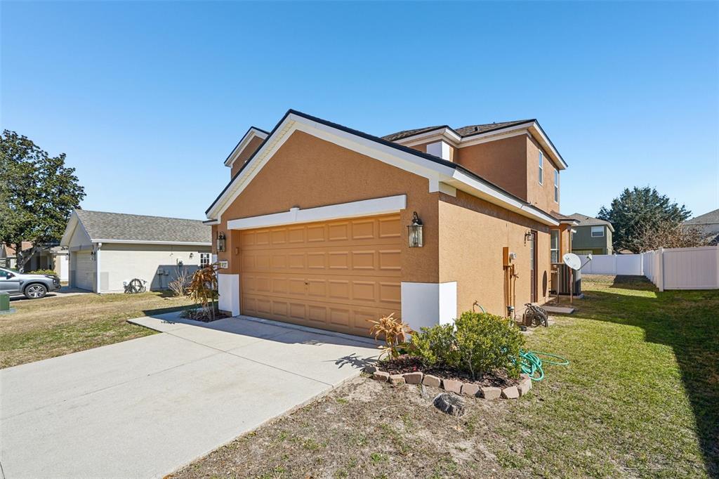 4127 Southwest 51st Court Ocala, FL 34474 - Photo 3 of 32 a view of a house with a yard and garage