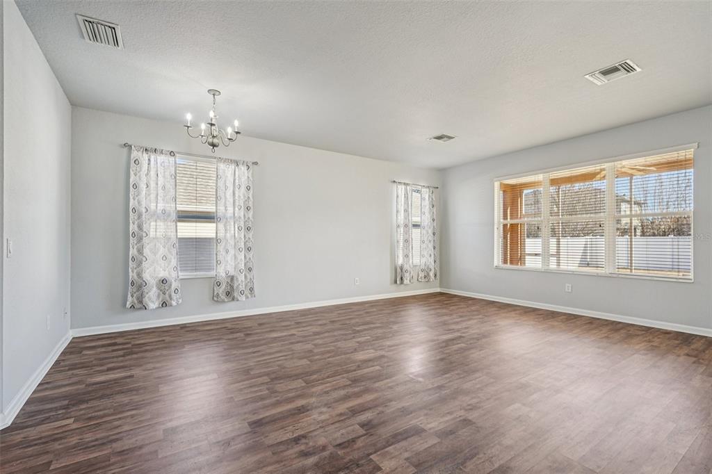 4127 Southwest 51st Court Ocala, FL 34474 - Photo 7 of 32 a view of an empty room with wooden floor and a window