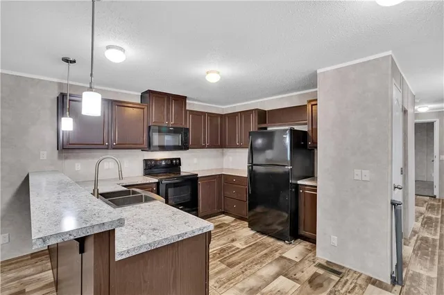 a kitchen with a refrigerator sink and wooden cabinets
