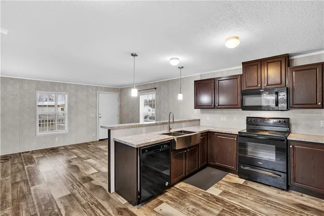 a kitchen with stainless steel appliances granite countertop a sink stove and oven