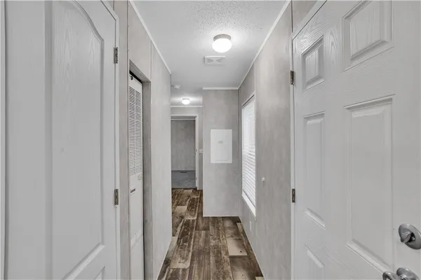 a view of a hallway with a wooden door