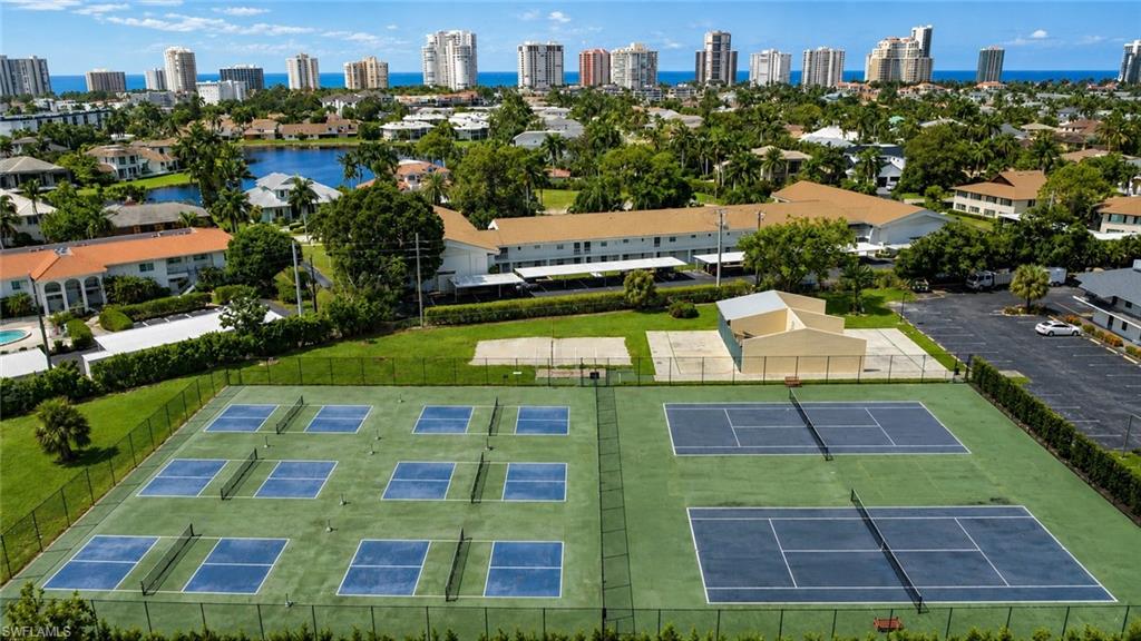 600 Neapolitan Way, Unit 449 Naples, FL 34103 - Photo 26 of 44 Expansive recreational area featuring multiple pickleball courts and two tennis courts