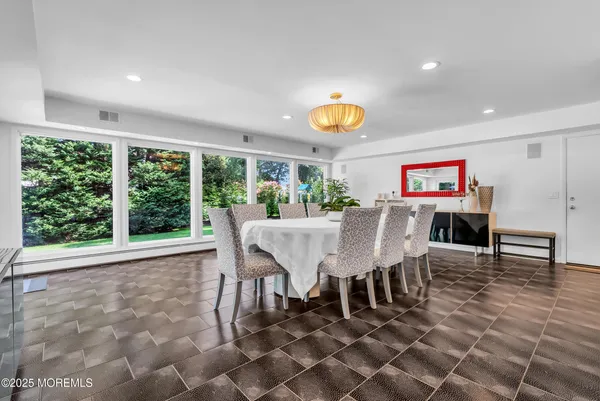 a large kitchen with a table and chairs