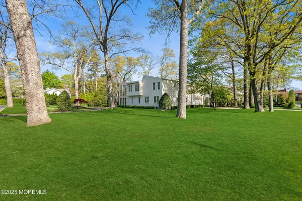 a view of house with backyard and outdoor seating