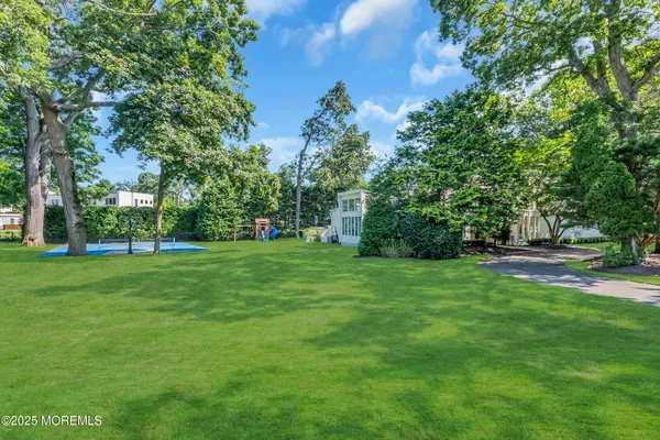 a view of a backyard with a garden and entertaining space