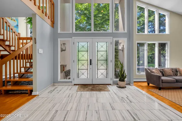 a view of an entryway with wooden floor