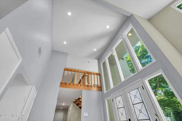 a living room with lots of furniture and glass door