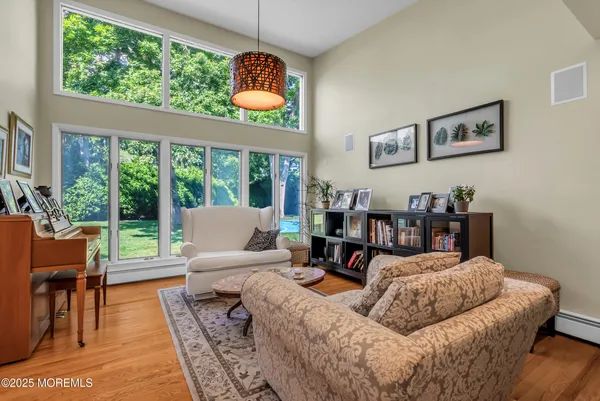 a living room with couches and kitchen view