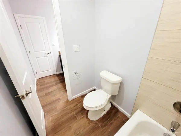 a white toilet sitting next to a small bathroom