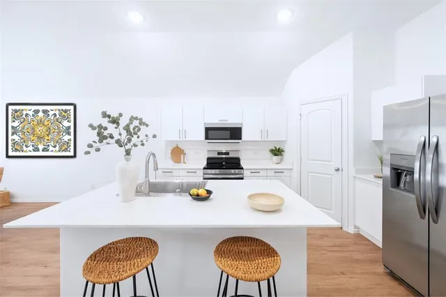 a kitchen with a table chairs and a refrigerator