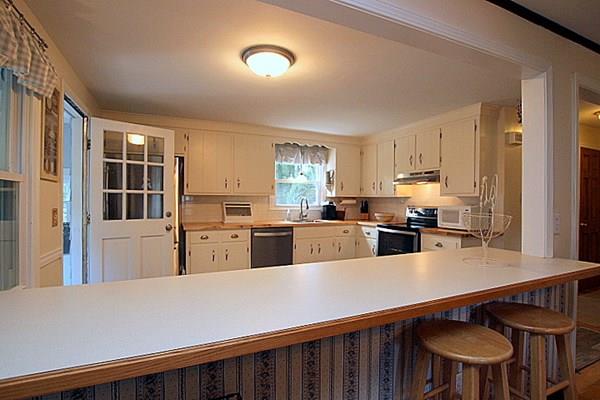 40 Old Farm Road North Attleboro, MA 02760 - Photo 20 of 36 a kitchen with stainless steel appliances a refrigerator and wooden cabinets