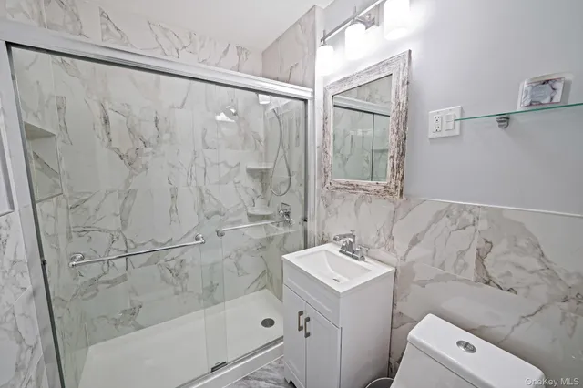 a bathroom with a sink a mirror and a shower