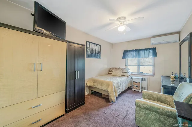 a bedroom with a bed couch and window