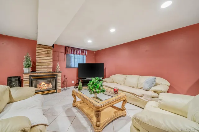 a living room with furniture a fireplace and a flat screen tv