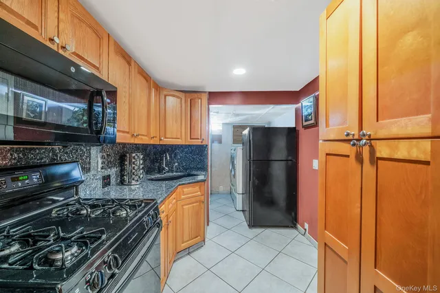 a kitchen with stainless steel appliances granite countertop a refrigerator and a stove top oven