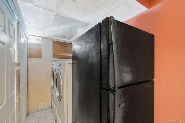 a metallic refrigerator freezer sitting in a room