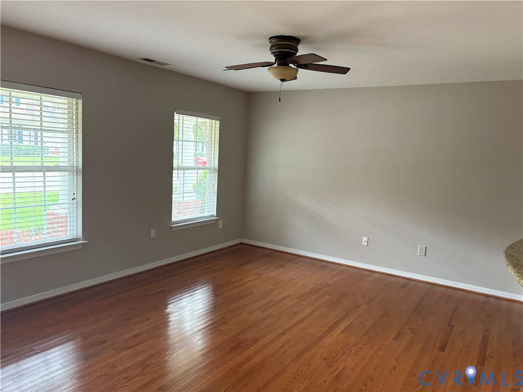 13628 Baycraft Terrace Midlothian, VA 23112 - Photo 5 of 24 a view of an empty room with wooden floor and a window