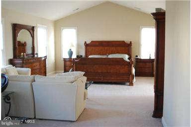 9129 Travener Circle Frederick, MD 21704 - Photo 15 of 28 a bedroom with a bed and a mirror