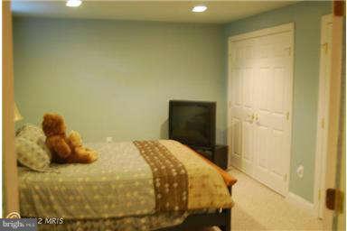 9129 Travener Circle Frederick, MD 21704 - Photo 19 of 28 a bedroom with a bed and wooden floor