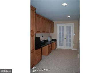 9129 Travener Circle Frederick, MD 21704 - Photo 20 of 28 a large kitchen with kitchen island granite countertop a sink and cabinets