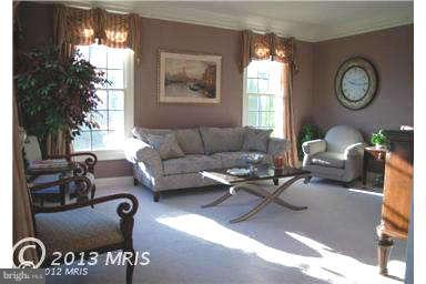 9129 Travener Circle Frederick, MD 21704 - Photo 4 of 28 a living room with furniture a large window and a clock
