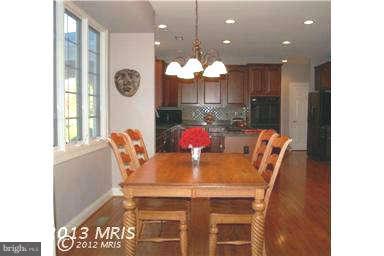 9129 Travener Circle Frederick, MD 21704 - Photo 8 of 28 a view of a dining room with furniture and a chandelier