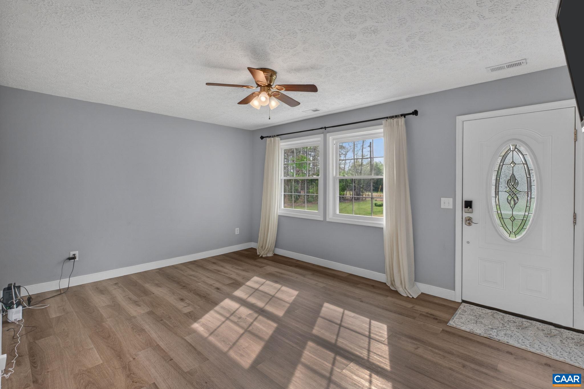 673 Cedar Lane Road Palmyra, VA 22963 - Photo 8 of 47 a view of room with window ceiling fan and wooden floor