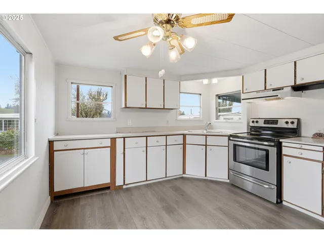 a kitchen with a refrigerator stove and white cabinets